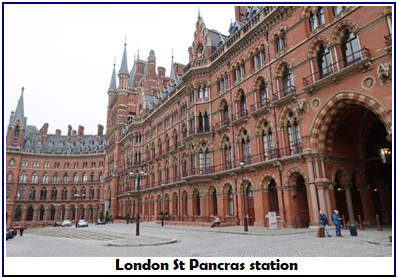 A large building with many windows with St Pancras railway station in the background AI-generated content may be incorrect.