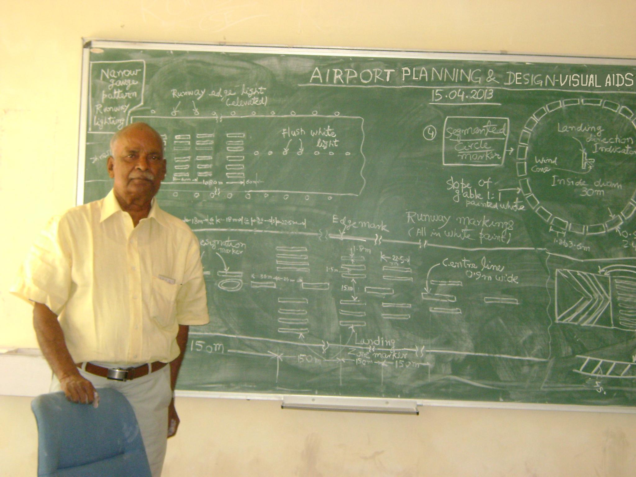 A person standing in front of a chalkboard Description automatically generated